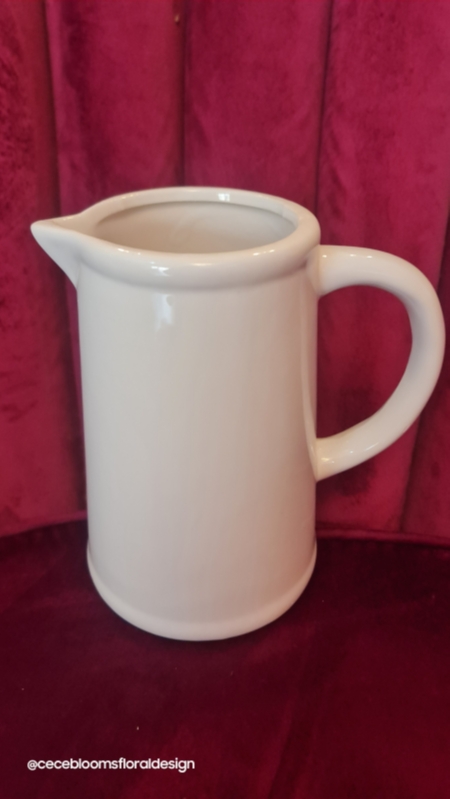 Jug with seasonal hand tied flowers.
