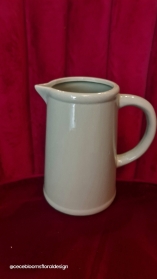 Jug with seasonal hand tied flowers.